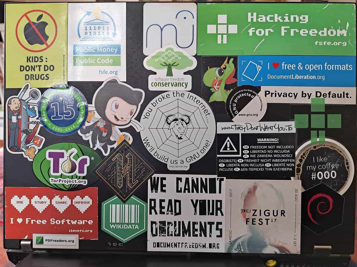 A laptop lid covered edge to edge in colourful stickers