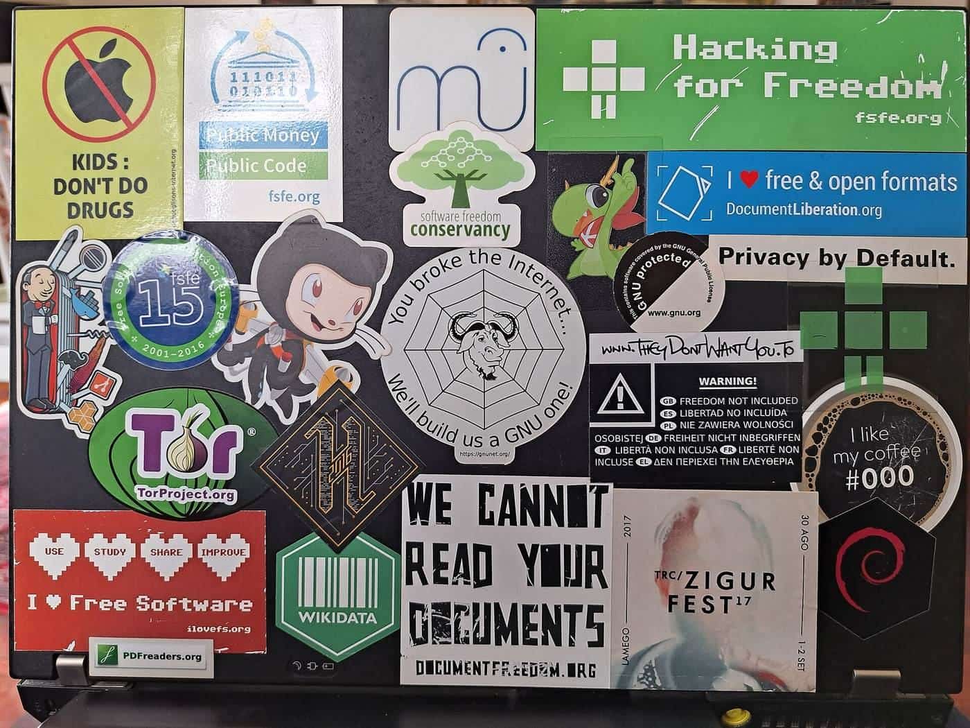 A laptop lid covered in dozens of colourful logo stickers