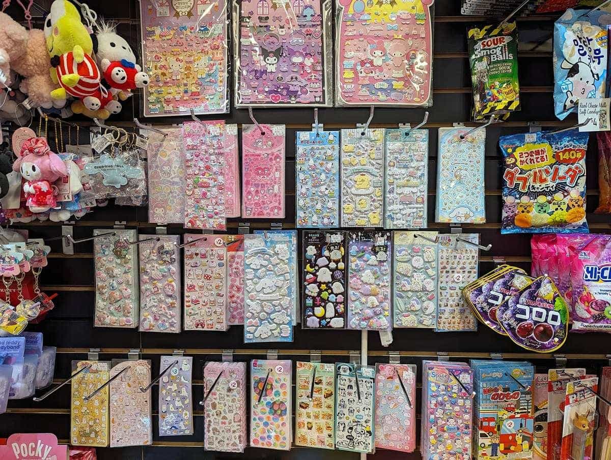 A shop wall display packed with colourful sticker sheets and small gifts