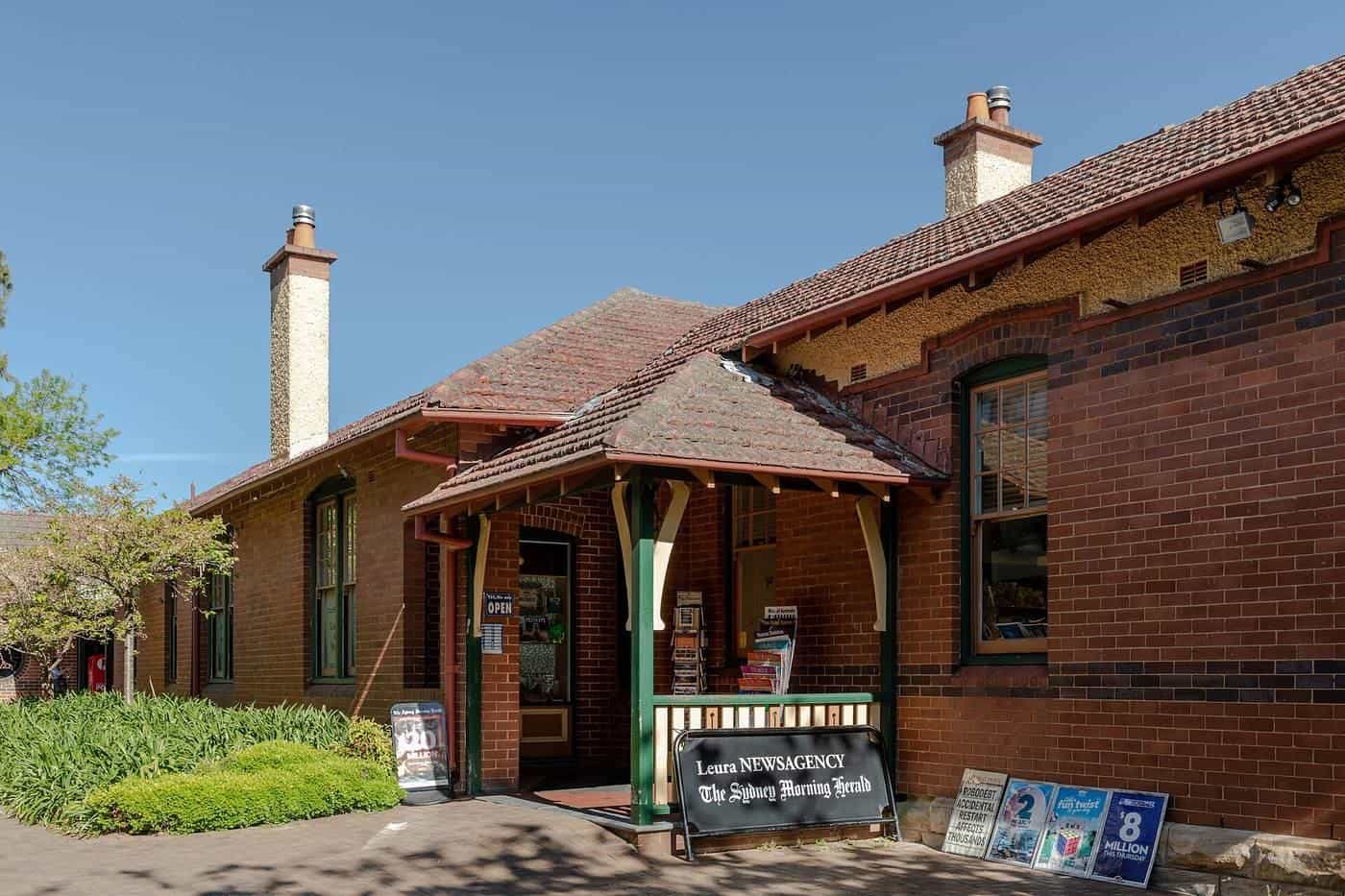 A heritage brick shop with a small sign out the front in the Blue Mountains town of Leura