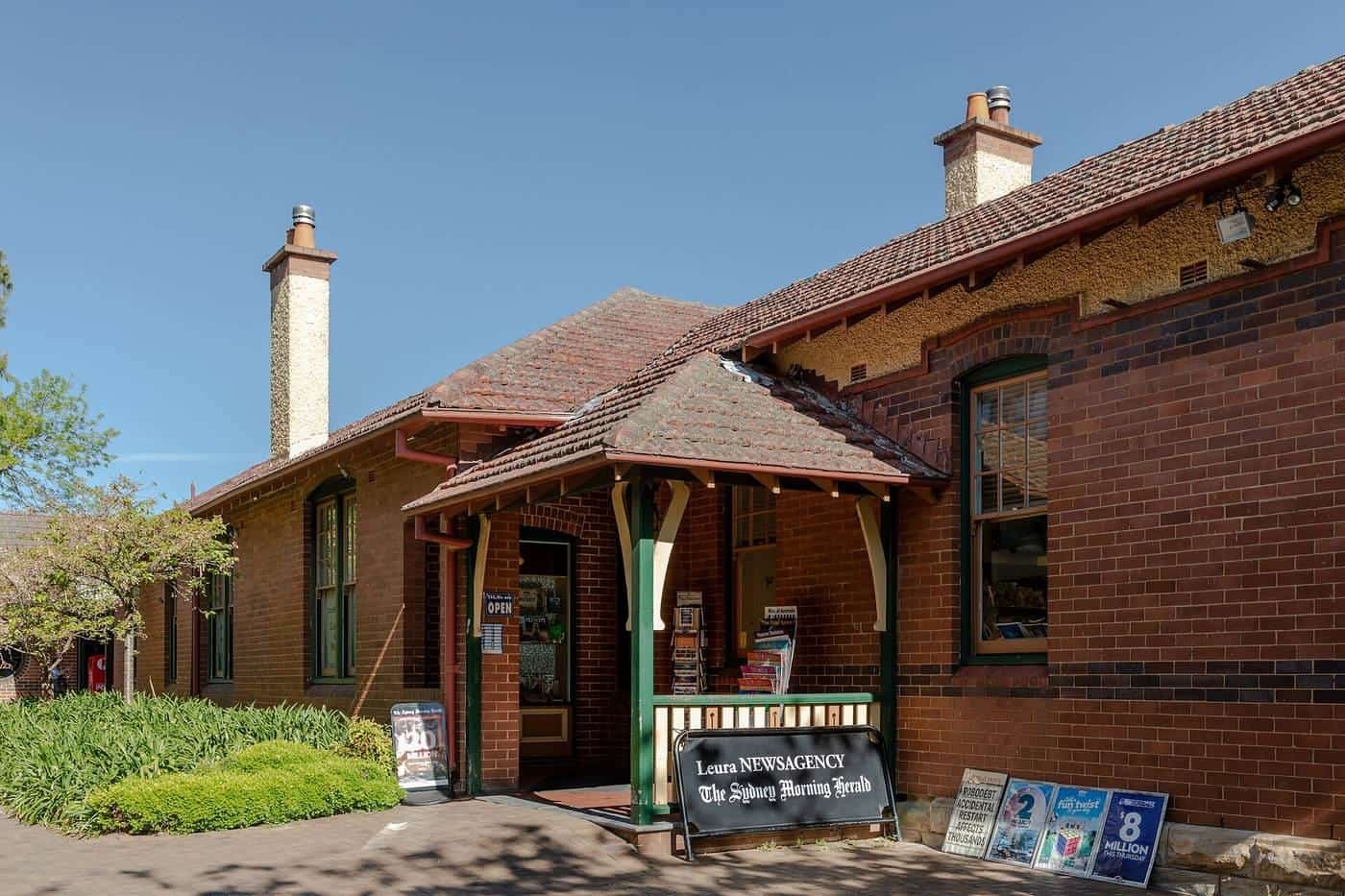 A heritage brick shop with a small sign out the front in the Blue Mountains town of Leura